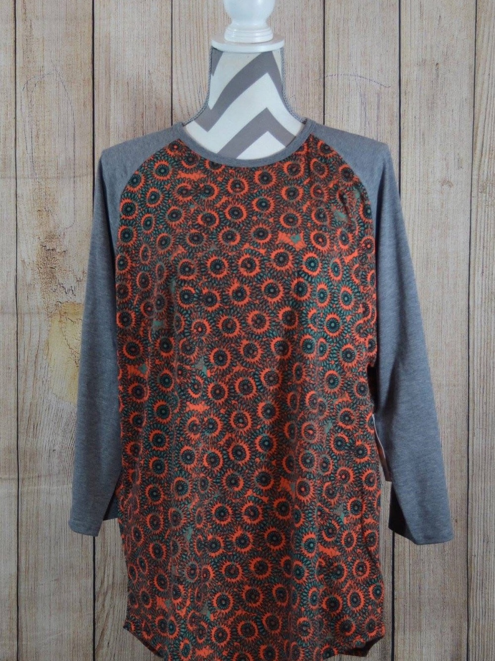 LuLaRoe Grey Sleeve Randy Top with Orange and Teal Circular Print